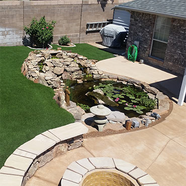 Landscaping with raised artificial turf area