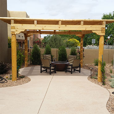 Southwestern style pergola with natural finish and latilla sun filtered roofing.
