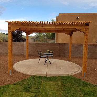 Southwestern style shade structure with latilla filtered sunlight roofing. 